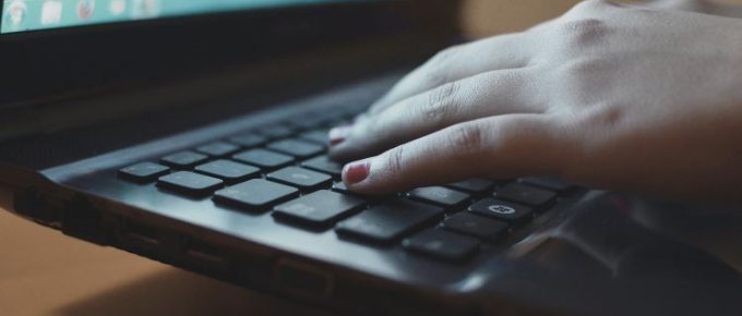 hand on laptop keyboard