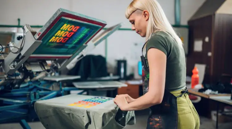 woman screen printing on a t-shirt